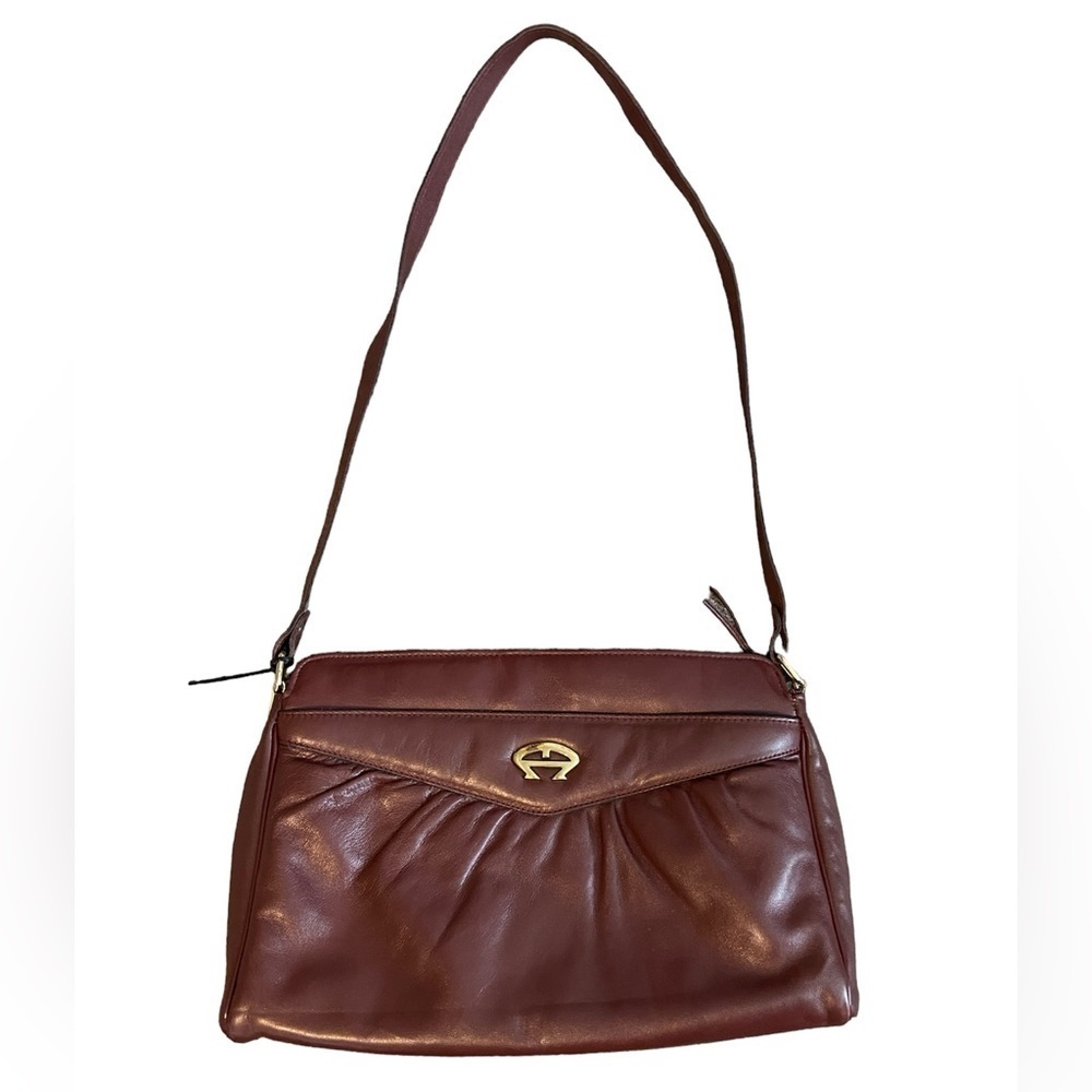 Etienne Aigner brownish, purple purse with strap.